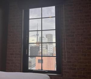 a bedroom window with a view of a city skyline at HOTEL TABARD TOKYO in Tokyo +50 photos