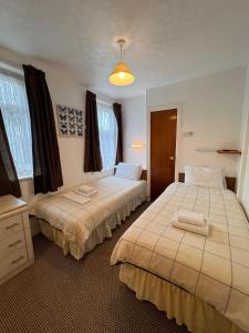 two beds in a hotel room with two beds at RideSide Hotel in Blackpool