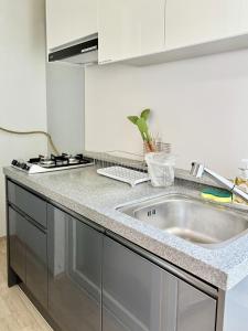 a kitchen with a sink and a counter top at Daegu Gyeongsan Stay in Gyeongsan