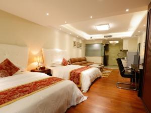 Letto o letti in una camera di Guangzhou Pengman Apartment Zhengjia Huanshi Branch