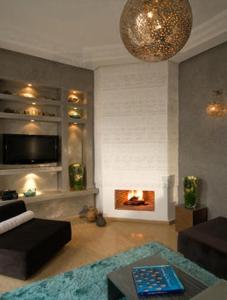 a living room with a couch and a fire place at Riad Chayma Marrakech in Marrakesh