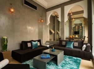 a living room with a couch and a table at Riad Chayma Marrakech in Marrakesh