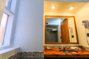 a bathroom with a sink and a mirror at Faraway in Villa La Angostura