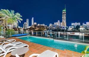 a swimming pool on top of a building with a city skyline at Honeymoon Retreat in Gold Coast