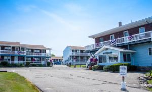 a row of houses with a sign in front of them at Inn Between the Beaches & Villager in York Beach