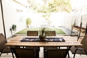 a wooden table with a potted plant on a patio at Horizon Village 15 in Windhoek