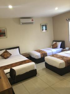 Un pat sau paturi într-o cameră la Soho Hotel Semenyih