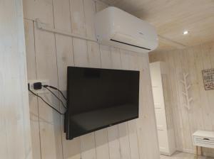 a flat screen tv hanging on a wall at Due cuori e... un Loft nel cuore antico di Aosta in Aosta