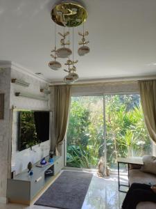 a living room with a large window and a couch at Villa Angelina La Baule in La Baule