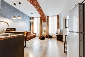 a kitchen and a living room with a refrigerator at Lovely Apartments Heart of Prague in Prague