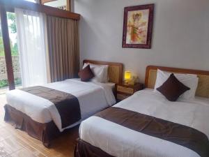 En eller flere senge i et værelse på Air ilir Grand Villa