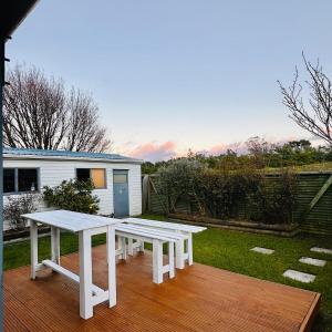 a white picnic table sitting on a deck at Waiwhetū 3 bedrooms house Retreat in Lower Hutt