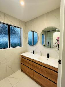 a bathroom with a sink and a mirror at Waiwhetū 3 bedrooms house Retreat in Lower Hutt