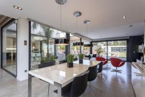 a dining room with a white table and chairs at Casa Joan Only Familes con Piscina Privada in Llubí