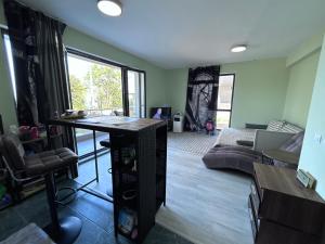 a living room with a table and a couch at морско бижу in Byala +24 photos
