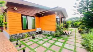 a small house with an orange exterior at The galilee farmhouse in Noida