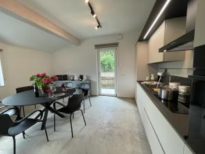 a kitchen with a table and some chairs in a room at LI BRE Aosta Charme Apartment in Aosta