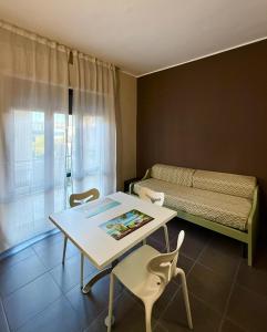 a room with a table and chairs and a bed at Pansini Hotel Residence in Badolato