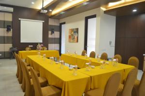 a conference room with yellow tables and chairs at Sweet Garden Guest House in Malang +41 photos