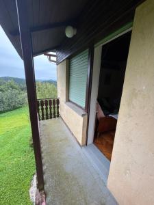 a balcony of a house with a window at Hiša p'r Kobalu- in Idrija