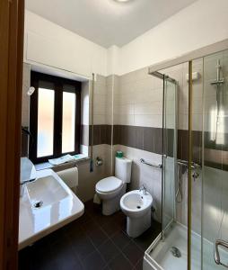 a bathroom with a toilet and a sink and a shower at Pansini Hotel Residence in Badolato +76 photos