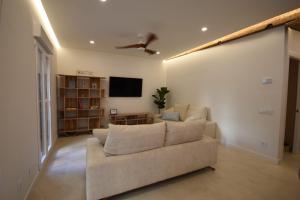 a living room with a couch and a flat screen tv at Sotileza Select Santander in Santander