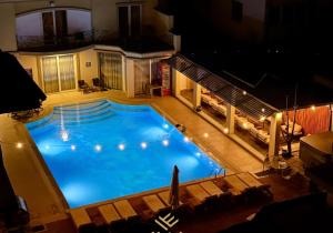 an overhead view of a large swimming pool at night at Hotel ERA in Prishtinë +24 photos