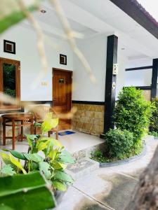 a front porch of a house with a wooden door at Puri Raka Villa in Pabean Buleleng