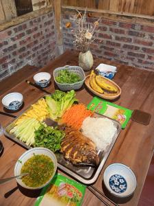 a table with a tray of food and vegetables on it at Lagom Home - Bamboo Forest in Sapa