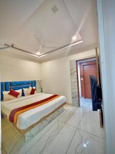 a bedroom with a king sized bed and a tv at Hotel Regal in Ahmedabad +8 photos
