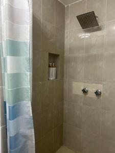a bathroom with a shower with a glass door at Pequeño Alojamiento in Cancún