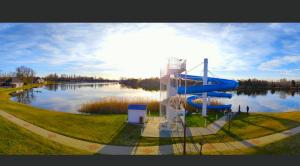 a water slide in the middle of a lake at Blue House Apartman Kék Ház Üdülő in Dunapataj