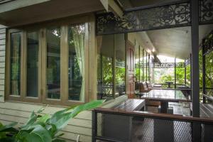 a screened in porch of a house with a table at Pai Panalee The Nature Boutique Hotel in Pai
