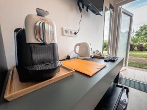 a coffee maker sitting on a counter in a kitchen at Sári Udvar in Dunakiliti