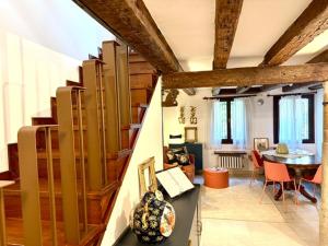 a living room with a staircase and a dining room at Domus Estia in Venice