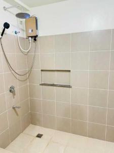 a bathroom with a shower with a shower at Vtan Condo in Manila +4 photos