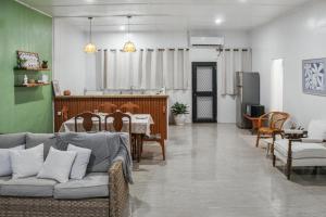 a living room with a couch and a dining room at Tiare Central 2BR Unit in Apia