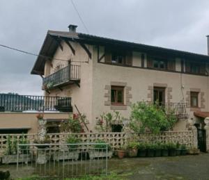 a large house with a fence in front of it at Alina leku in Zarátamo