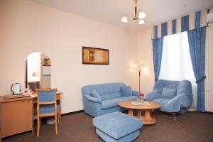 a living room with two blue chairs and a table at Tourist Hotel in Moscow