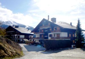 a large apartment building with a snow covered mountain at Iris I 031 - CONFORTABLE apartment 6 pers in Veysonnaz