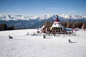 a group of people on a ski slope in the snow at Iris I 031 - CONFORTABLE apartment 6 pers in Veysonnaz +4 photos