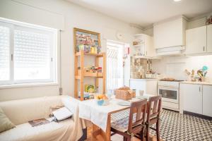 a living room with a table and a couch at Alex Point - Guest House in Viana do Castelo