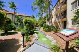 a resort with a golf course in front of a building at Turtle Beach 250 in Gold Coast