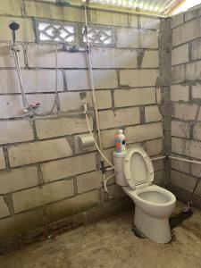 a bathroom with a toilet in a brick wall at RAMMANG-RAMMANG HOUSE in Maros +35 photos