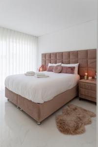 a bedroom with a large bed with a brown headboard at SIHEM ‘S Villa Luxury House in Santa Barbara +21 photos