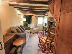 a living room with a couch and a table at Old Cottage in Ulverston