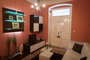 a living room with a white couch and a door at Apartment Bozic in Lovran