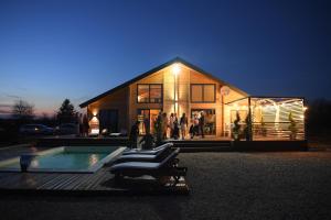 a group of people standing outside of a house at Casa del Corniolo Spa and Pool House Fruška gora in Čortanovci