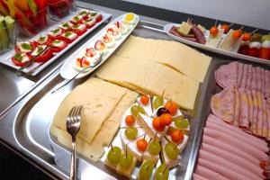 a display of cheese and meats on a table at Hotel Garni Hutter in Unterburg am Klopeiner See +140 photos