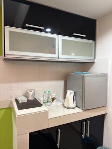 a kitchen with a counter with a microwave at The Viana Apartment 6 in Kota Bharu
